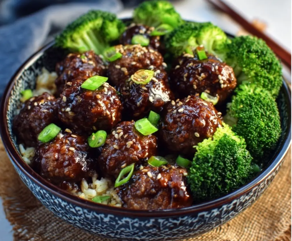 Delicious Sticky Mongolian Meatballs served with fresh broccoli on a modern plate