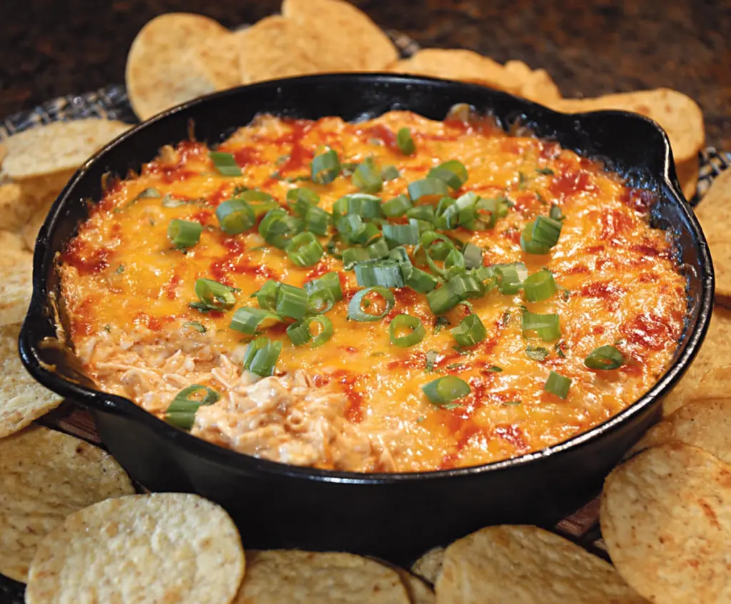 Creamy BBQ chicken dip served with tortilla chips, perfect for parties and gatherings.