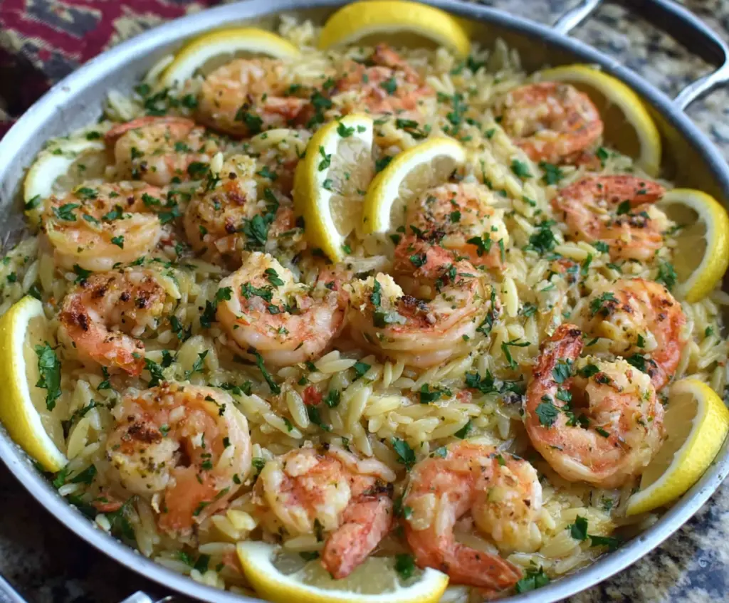 Delicious Shrimp Orzo in a zesty Lemon Garlic Sauce served on a white plate.